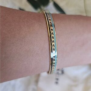 Coach Signature C bangle bracelet in gold with black and soft green/blue accents